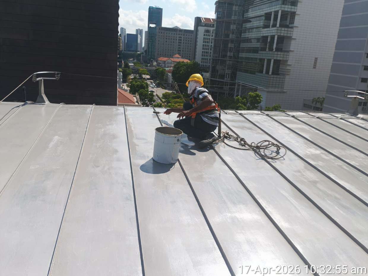 RR Engineering worker applying a protective roof coating