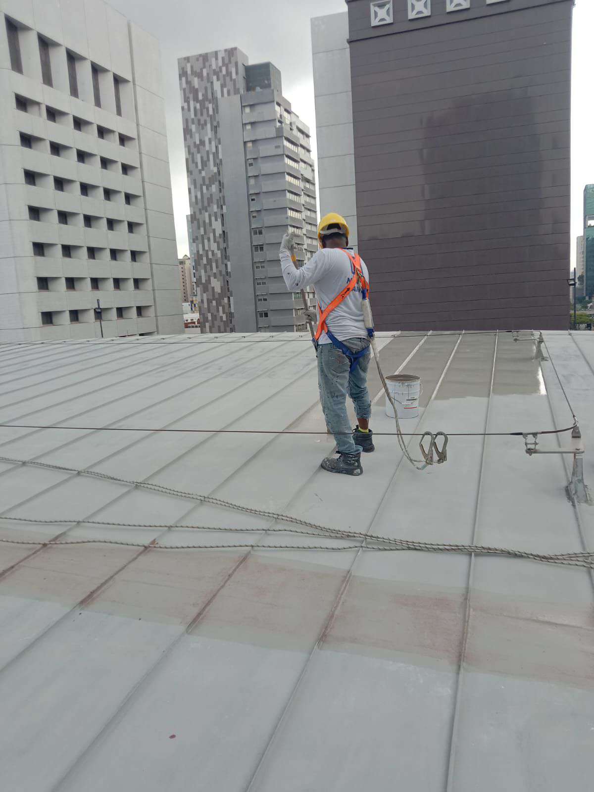 RR Engineering worker completing roof coating works